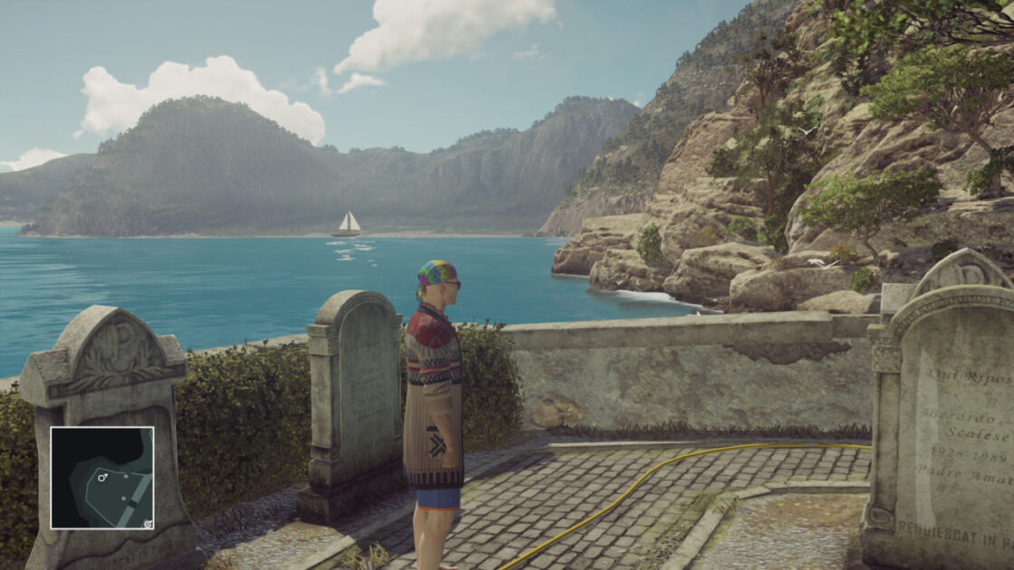 Agent 47, back in his hippie clothes, exploring a beachside graveyard